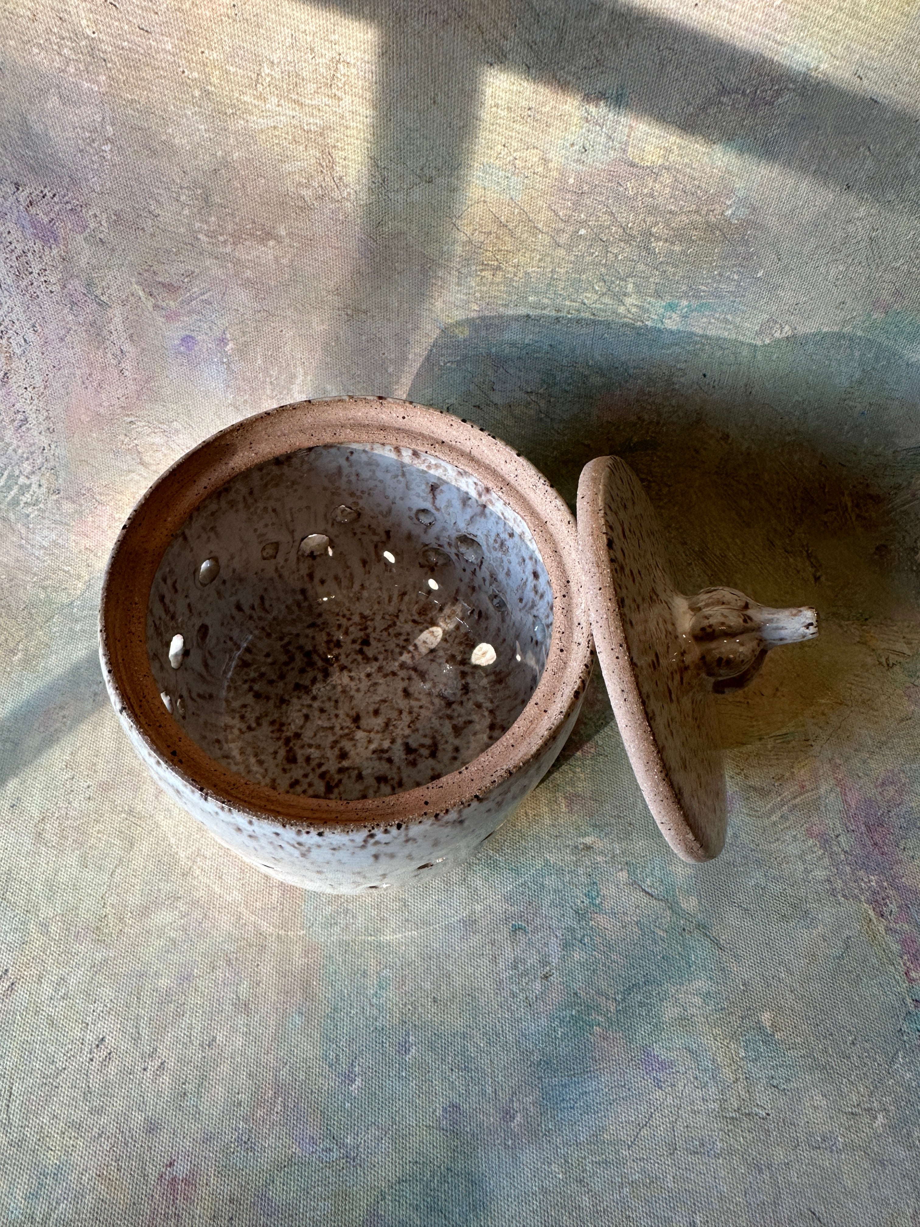 Wheel thrown stoneware garlic keeper with scupted garlic knob