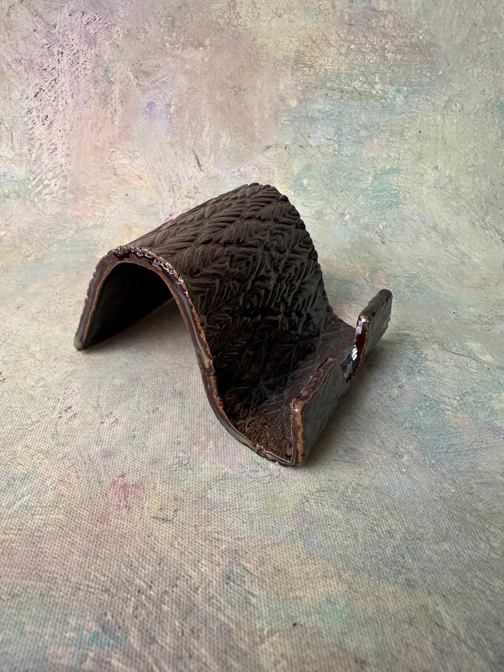 Brown pottery cell phone holder