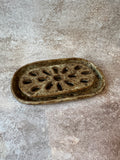 An oval ceramic 2pc soap dish with a decorative cutout pattern to allow your bar soap to drain.